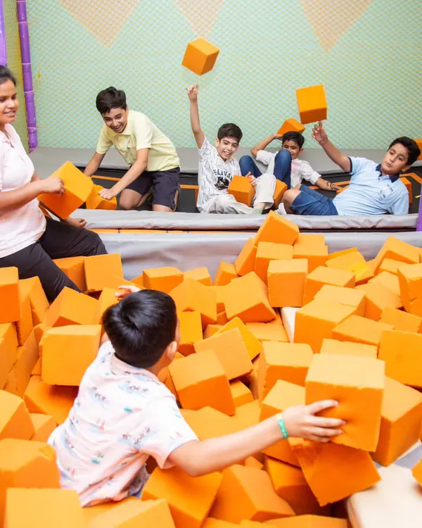 The energy is always high in our foam pit! It's part of our large, safe play zone where kids can jump, tumble, and play to their heart's content.