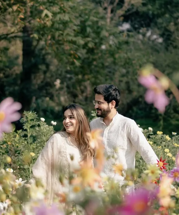 A dreamy portrait of a couple in a field of wildflowers. I use the flowers in the foreground to create a soft, romantic frame, making the scene feel like a painting.