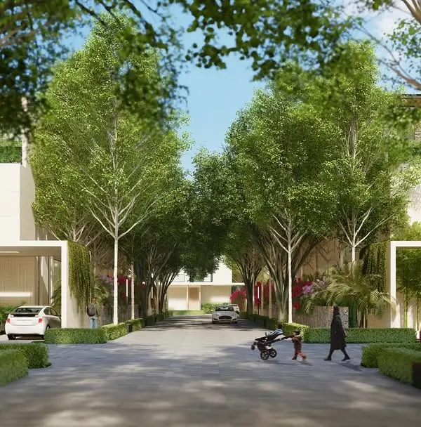 A view down the central street of Aranya Villas, where families can walk and children can play. The design prioritizes pedestrian friendly spaces and a strong connection to nature, creating a safe and serene community environment.