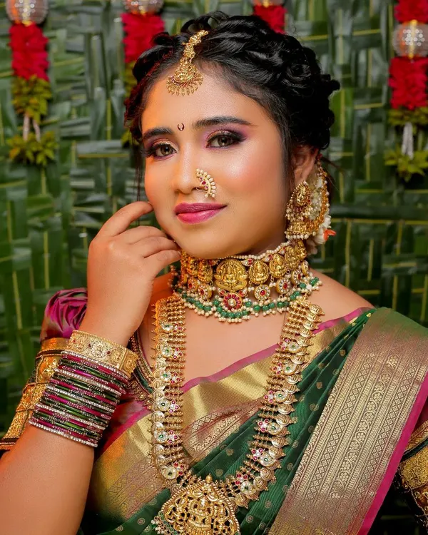 A complete traditional look featuring flawless makeup with a focus on the eyes, an elegant braided updo, and perfectly coordinated temple jewelry. This is the result of my full-service styling.