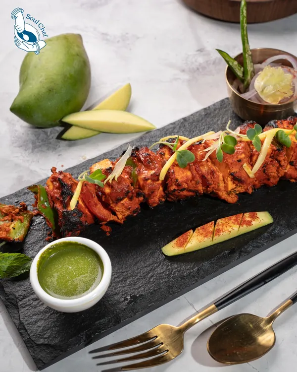 Our Mango Paneer Tikka is a signature dish, perfectly embodying our fusion philosophy. The smoky, spiced paneer is beautifully complemented by the tangy sweetness of raw mango.