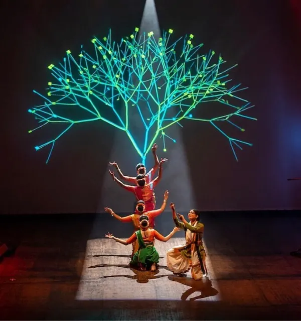 This is a moment from my production 'Antariksha Sanchar', a science-fiction dance opera. Here, my students and I perform against a backdrop of stunning visuals, blending the timeless storytelling of Bharatanatyam with new media art to create a unique theatrical experience.