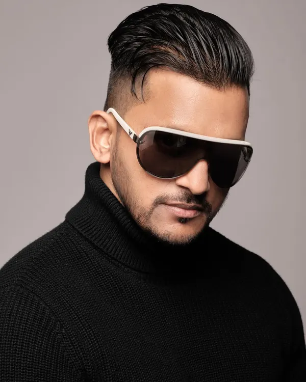 A professional headshot from a recent photoshoot. I believe in presenting a sharp and stylish image that complements the high-end corporate events I perform at.