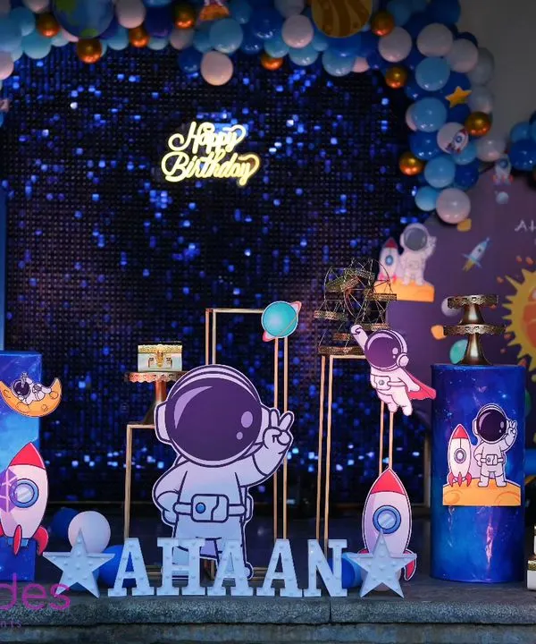 A complete space-themed birthday party setup. We designed a galaxy backdrop with a balloon arch, planet cutouts, and a personalized name sign for the birthday boy, Ahaan.