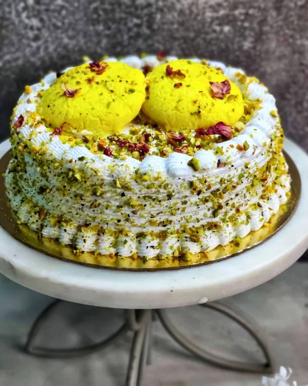 This is my signature Rasmalai Cake, a true celebration in every bite. I craft it with a soft, saffron-infused sponge, layer it with creamy rabdi, and top it with delicate rasgullas. It’s a perfect example of how I blend traditional Indian desserts with modern baking.