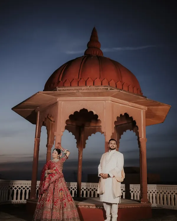 Against the twilight sky at Umaid Palace in Jaipur, this shot is a testament to quiet strength and royal elegance. It’s a moment of stillness before the grand celebration, where love is the only thing that matters.