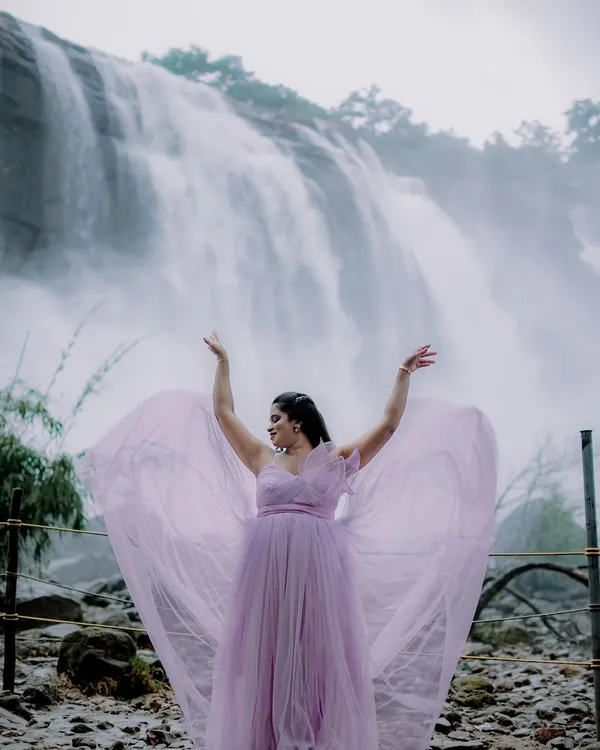 This is the magic I want for your pre-wedding shoot. Imagine yourself in this breathtaking lavender gown, with the tulle fabric catching the breeze against a stunning natural backdrop like this waterfall. It’s all about creating those epic, cinematic moments you'll cherish forever.