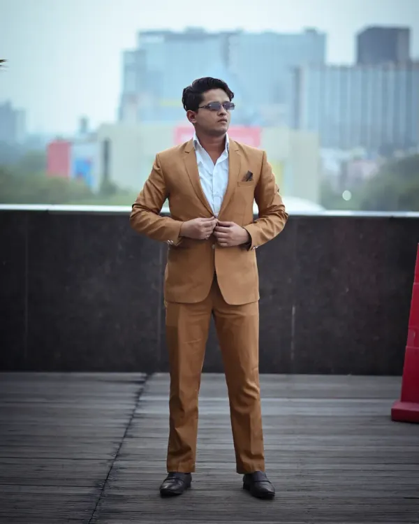 A classic full-length pose for a corporate lookbook. The model is adjusting his suit jacket, which gives the photo a natural, in-the-moment feel while still looking professional and sharp.