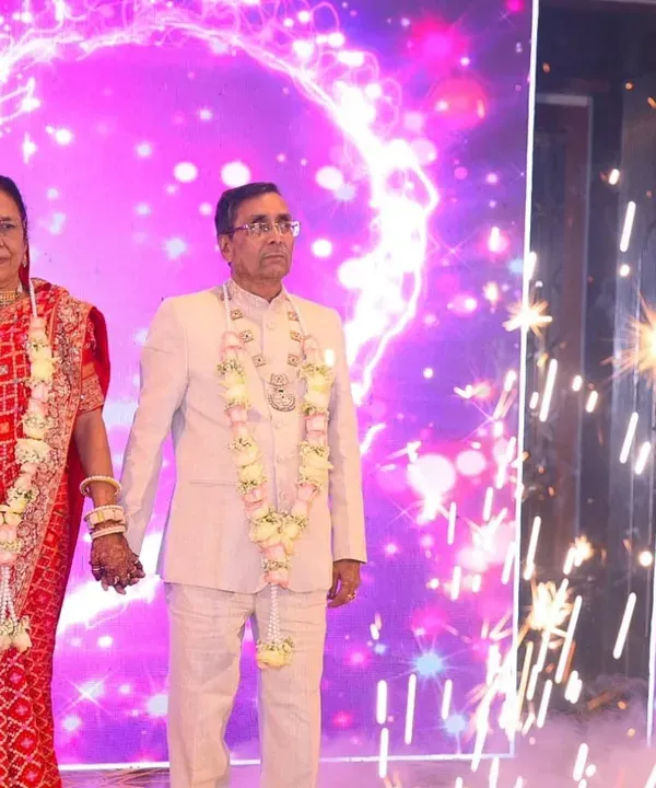 The anniversary couple makes a grand entrance with sparklers and smoke, creating a magical and cinematic moment.