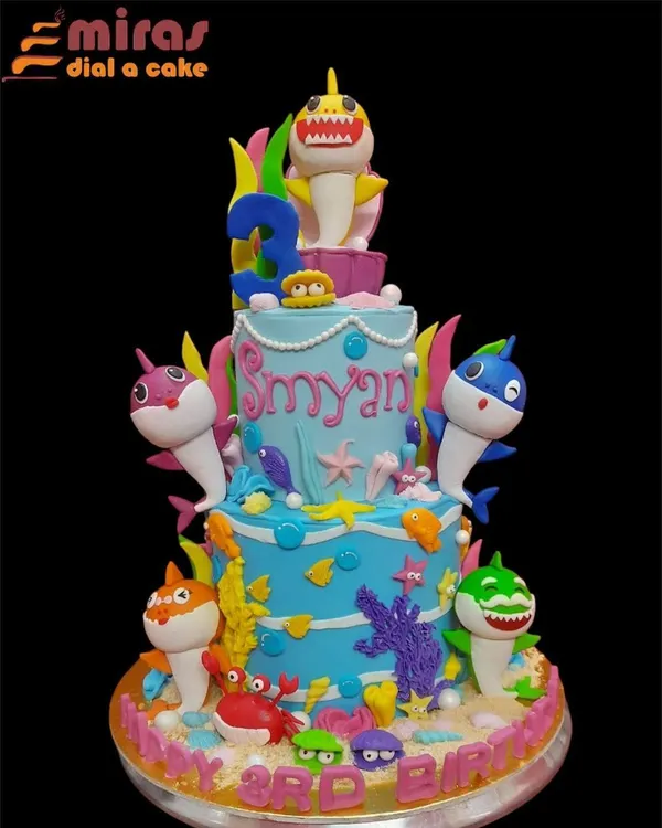 Dive into an underwater adventure with this spectacular three-tier Baby Shark cake. The entire shark family is here, surrounded by colorful coral, sea creatures, and sandy textures, making it a showstopper for a third birthday.