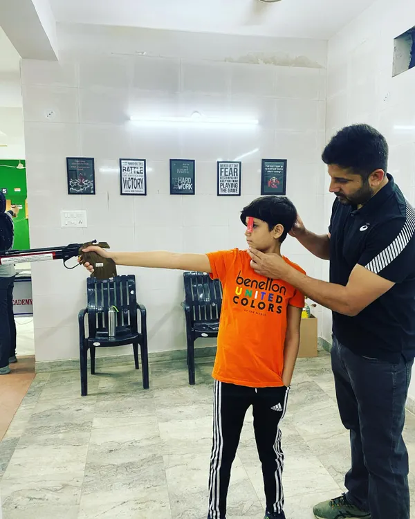 Every champion starts with the basics. Here, I am providing one on one instruction to a young shooter, correcting his stance and grip for the air pistol. I believe in building a strong technical foundation for shooters of all ages.