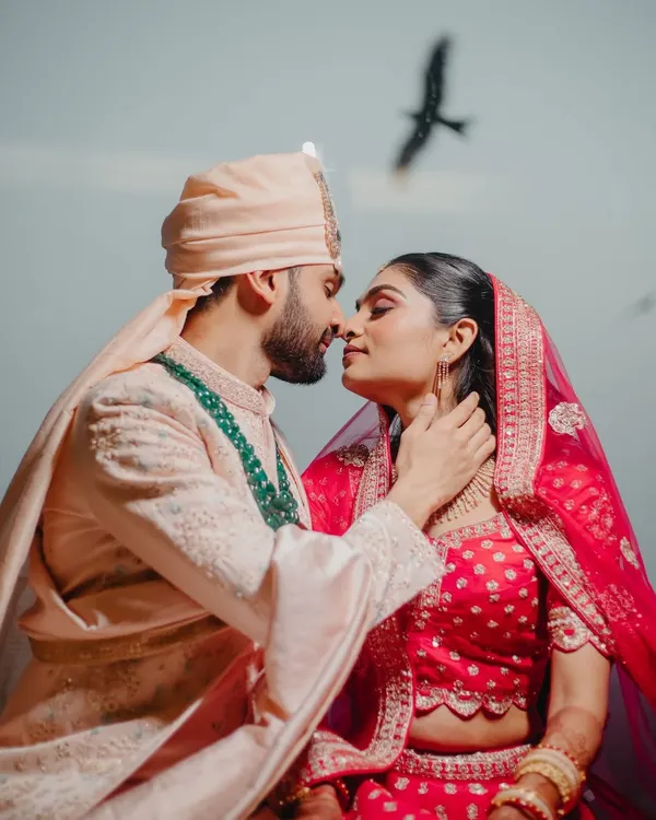 An intimate couple portrait with a bird flying overhead, adding a touch of serendipity. We look for these magical elements to make your photos unique.