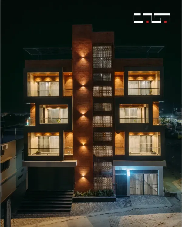 This residential building in Pushkar, Rajasthan, is a testament to our design philosophy. We blended traditional Rajasthani jaali work with a modern, multi-level structure, creating a facade that is both culturally rooted and contemporary. The strategic use of exterior lighting accentuates the architectural form and the intricate details, making a striking statement against the night sky.
