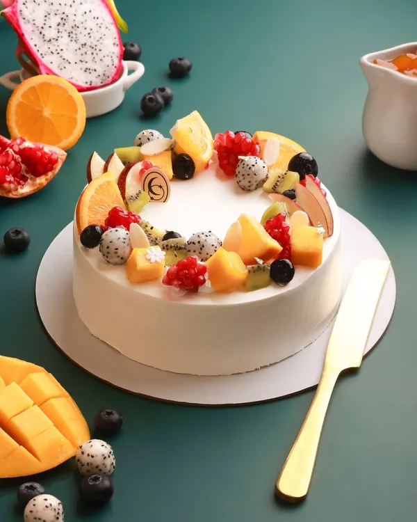 Taste the sunshine in every slice. Our Summer Fruit Cake is filled with layers of light cake, silky custard cream, and a colorful crown of seasonal fruits like mango, dragon fruit, kiwi, and berries.