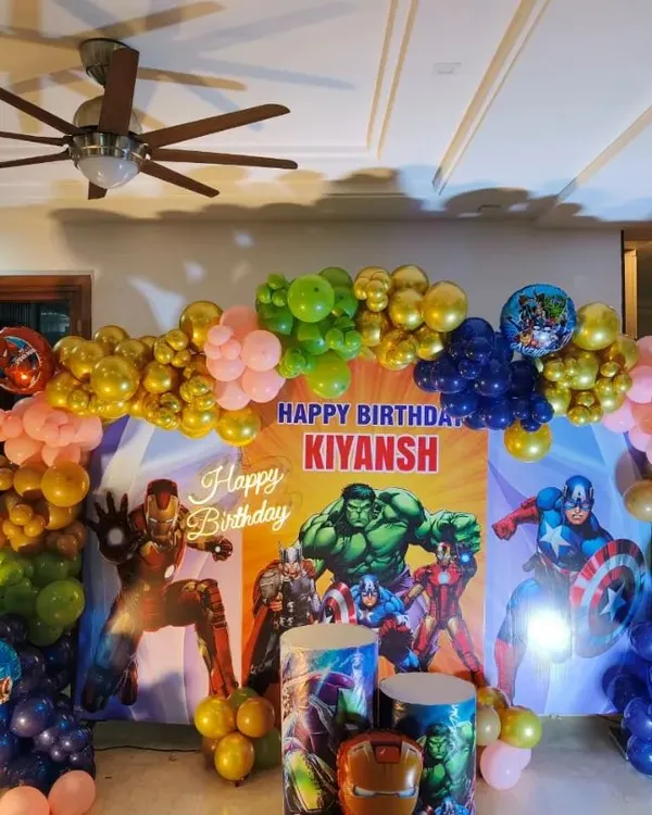 An action-packed Avengers theme for a 6th birthday. This setup features a large backdrop with Hulk and Captain America, a colorful balloon arch, and character cutouts of Iron Man and Spider-Man, perfect for a young superhero fan.