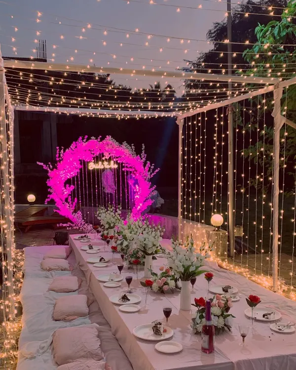 This intimate bridal shower setup by the poolside is one of my favorite designs. I created a magical ambiance with a canopy of fairy lights and a low-seating arrangement, perfect for a memorable evening under the stars.