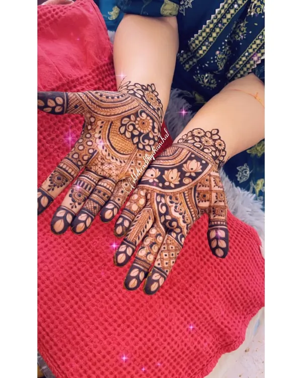 A beautiful, bold design with paisley and floral motifs, showing a rich, dark henna stain.