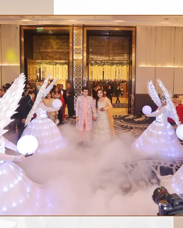 A grand entrance for a love story just beginning. I focus on capturing these spectacular moments, making the couple feel like stars in their own movie, complete with dramatic smoke and ethereal angel performers to light the way.