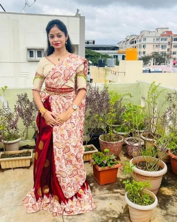 I designed this beautiful lehenga with intricate handwork on the blouse sleeves and a unique back design. The client is wearing it on her terrace garden.