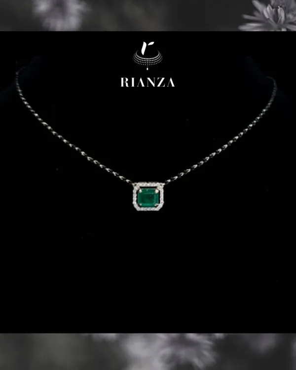 A modern take on a traditional symbol, this mangalsutra features a precious emerald gemstone surrounded by a halo of diamonds. It is designed for the contemporary bride who wants to stand out.