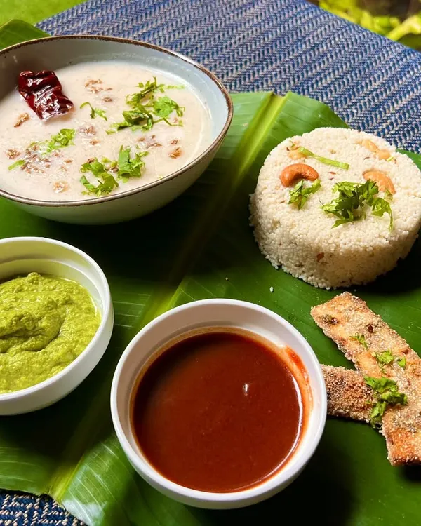Experience the flavors of Shravan with our delicious Jeera Kaju Varai Pulao served with Dahi Kadhi. This complete meal is a perfect blend of tradition and taste, presented beautifully on a banana leaf.