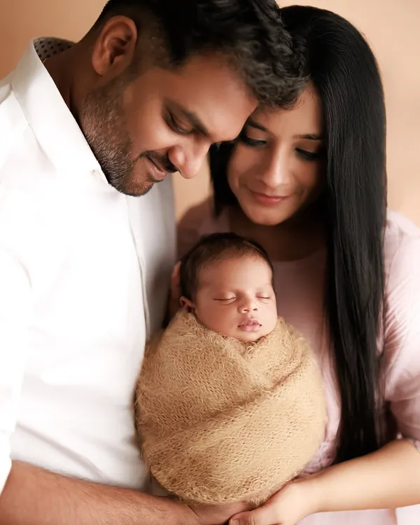 A perfect, peaceful moment for new parents adoring their swaddled newborn. These studio sessions are designed to be calm and intimate, focusing on the blessing of your new arrival.