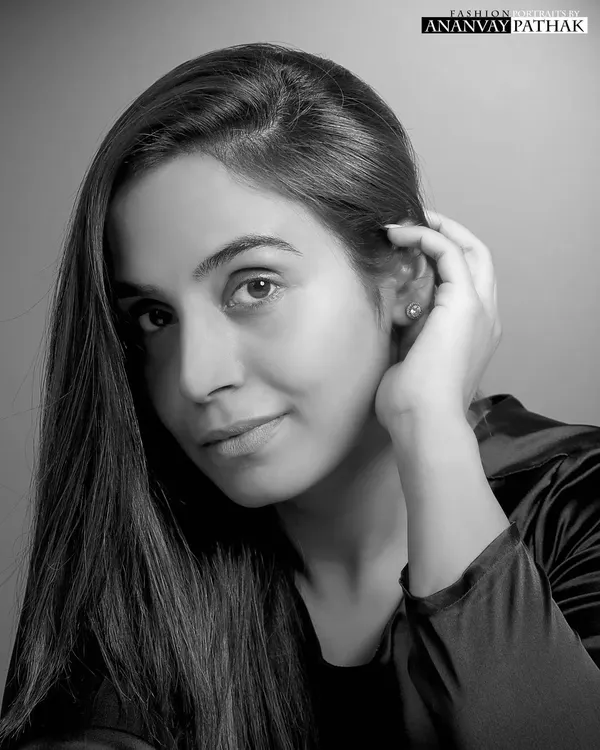 A classic black and white headshot is a timeless addition to any portfolio. This portrait offers a clean, direct, and elegant look, focusing on the model's natural features and expression.