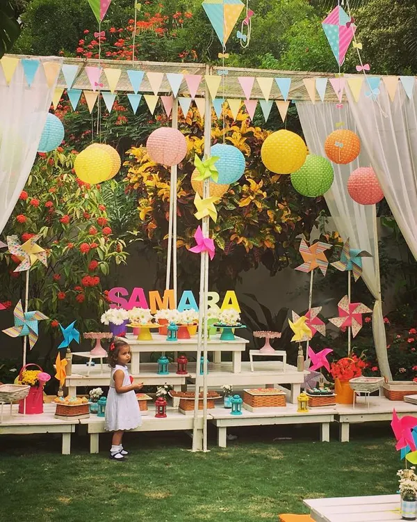A delightful summer picnic party for a 2nd birthday. The setup featured a dessert canopy decorated with colorful lanterns, pinwheels, and kites for a fun, breezy feel.