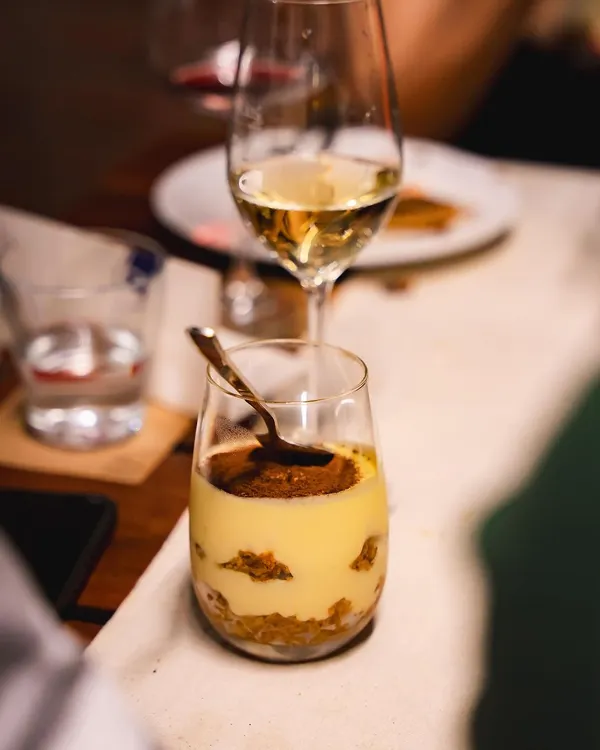 Our classic Tiramisu, served in a glass. We layer coffee-soaked ladyfingers with a light and creamy mascarpone mixture, finished with a dusting of cocoa powder.