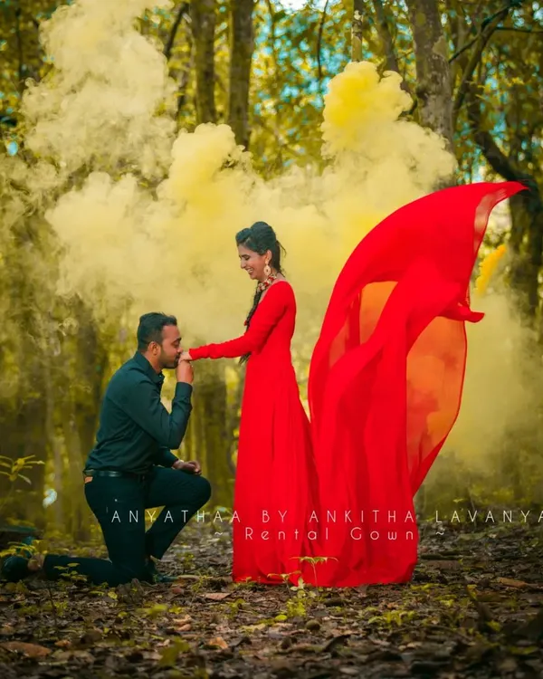 A romantic moment from a pre-wedding shoot, enhanced by the vibrant red of my rental gown and a dramatic smoke effect. This gown is designed to make a statement in any setting.