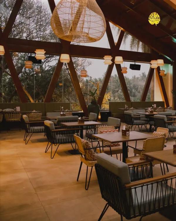 The interior of our rooftop restaurant, Botanica, with its distinctive A-frame architecture and views of the surrounding trees. It's a beautiful space for dining, day or night.