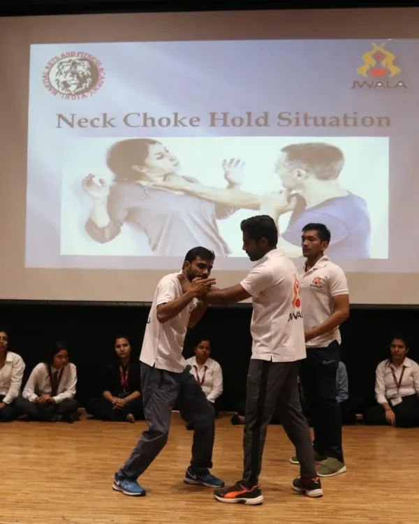 Demonstrating a defense against a neck choke hold during a workshop for over 250 female students at GL Bajaj Institute. Practical skills for real-world safety.