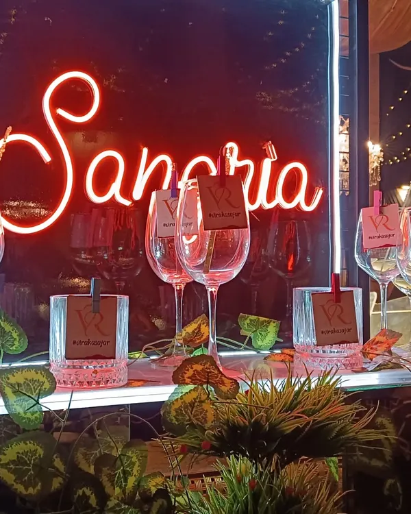 A close-up of our popular Sangria station, complete with a neon sign and personalized glass tags featuring the couple's initials. It's a stylish and interactive way for guests to enjoy a refreshing drink.