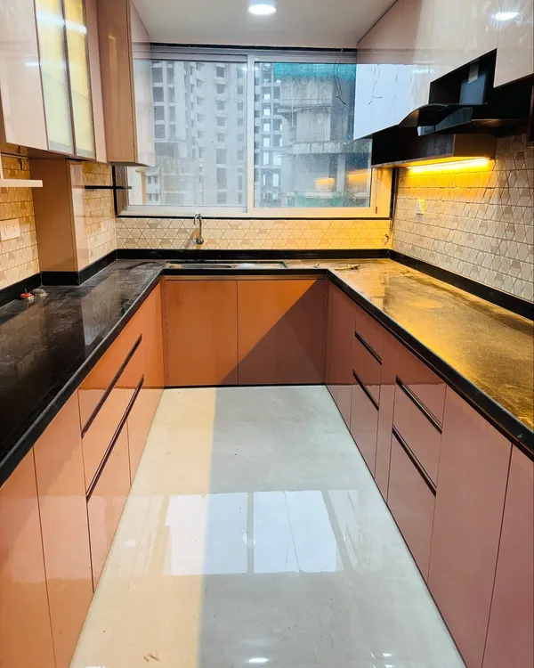 A clear view of a U-shaped kitchen layout, which offers extensive counter space and storage on three walls. This design is perfect for maximizing functionality in a dedicated kitchen area.