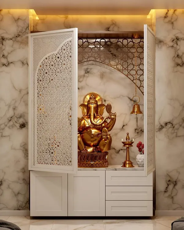 An elegant pooja unit I designed with intricate jali-work doors. The interior features a marble-finish back panel and warm backlighting to create a divine ambiance.