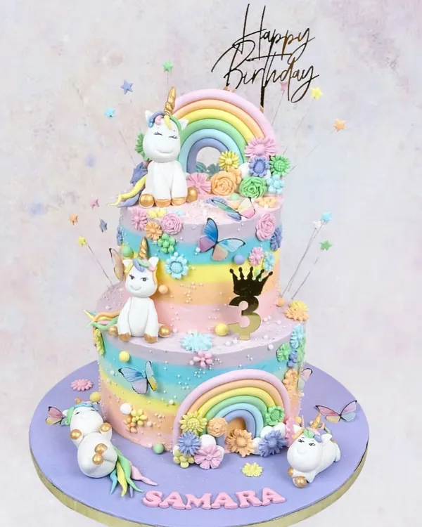 A magical two-tier unicorn cake for Samara's 3rd birthday. With pastel rainbows, fluffy clouds, and adorable unicorns, this cake is what sweet dreams are made of.
