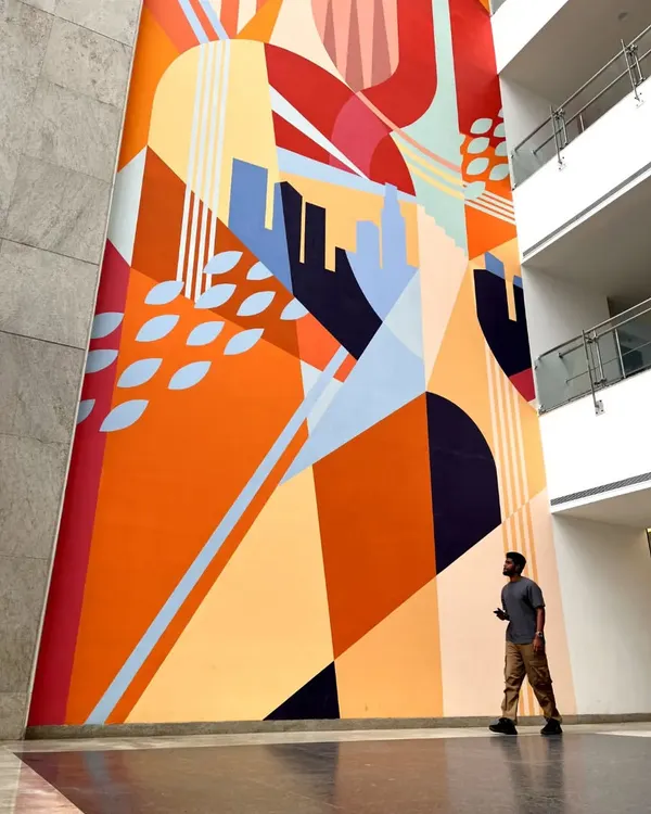This 100-foot tall mural for the Embassy Group is a story of harmony between nature and urban development. The abstract design uses bold colors and shapes to create a landmark piece in their corporate lobby.