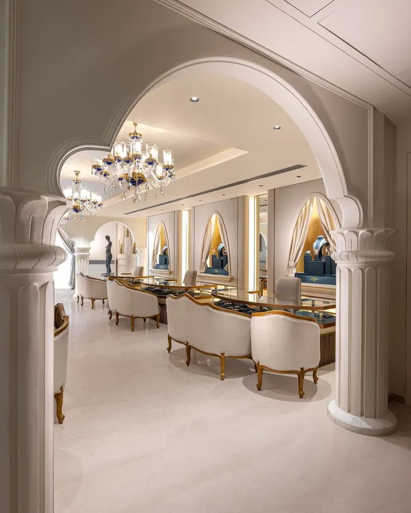 A view through the grand arches of a luxury jewellery store we designed. The space is organized to create private, elegant consultation areas, with plush seating and custom display counters that make the selection process a personal and luxurious affair.