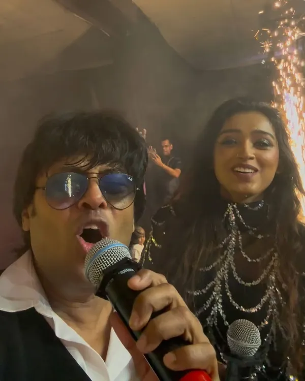 A selfie with my co-singer right before hitting the stage, with the pyrotechnics going off behind us. The calm before the storm!