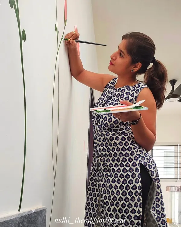 Here I am at the beginning of a new project, laying down the first delicate stems of a lotus mural. Every big piece starts with a single, focused line.