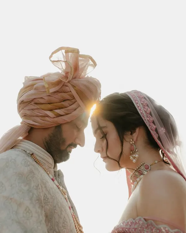 A moment of pure stillness against the light. This close-up of the couple, their foreheads touching, captures the deep, unspoken connection that is at the heart of every love story.