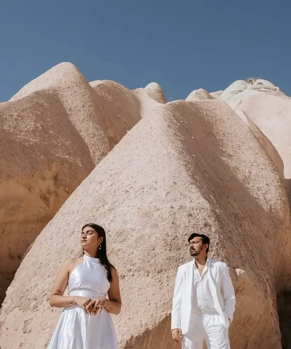 Dressed in white against the unique rock formations of Cappadocia, Turkey, Kashish and Simran create a striking, high-fashion portrait. This is an example of how we use dramatic landscapes to create editorial-style pre-wedding images.
