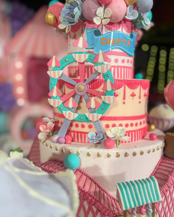 A close-up of the carnival cake's centerpiece, a hand-painted, edible ferris wheel. My background in architecture means I get obsessed with creating these structural, detailed elements that make a cake truly special.