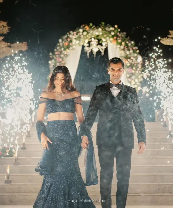A grand entrance for the couple at their reception, walking through a tunnel of sparklers held by their loved ones. I orchestrate these high-impact moments to create unforgettable memories.