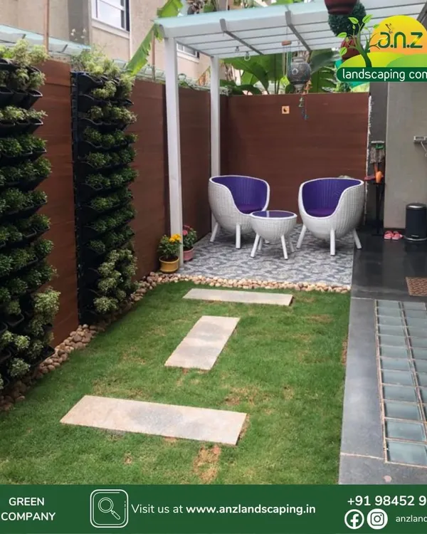 A compact backyard transformed with vertical gardens on the walls, a small lawn, a stone pathway, and a cozy seating area under a mini-pergola.