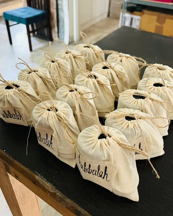 A large order of my handmade products ready for a corporate event. Each item is individually packed in an eco-friendly cloth pouch, showing that even bulk orders have a personal, handcrafted touch.
