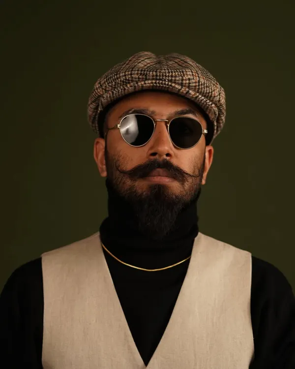 A direct and confident portrait from a studio session. This style is effective for classic menswear, eyewear promotions, and portfolio headshots that require a strong presence.