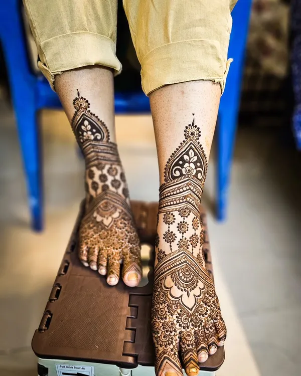 A stunning, full-coverage design for the feet, matching the intricacy of a full bridal henna for the hands.