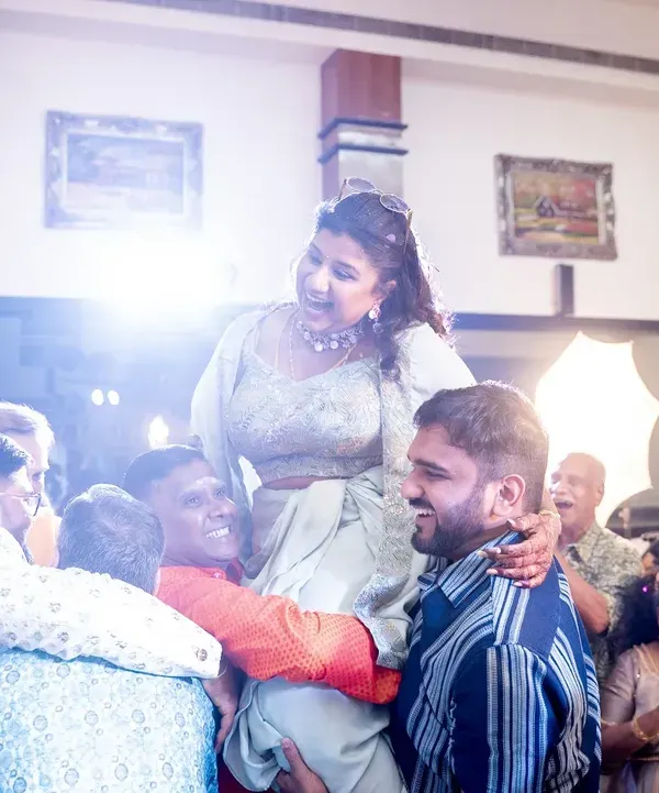 The bride being lifted up by her friends and family in a moment of pure celebration. These are the high-energy, unforgettable moments I strive to create.