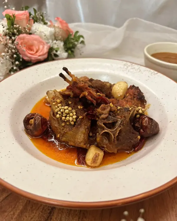 Experience the fiery taste of Rajasthan with our Junglee Maas. This spicy dry lamb curry is slow-cooked in A2 cow ghee with confit garlic and boriya chili, creating a bold and unforgettable flavor.